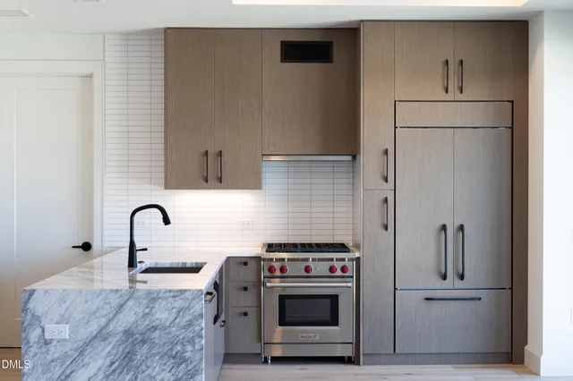 a bedroom with a large bed and a balcony view