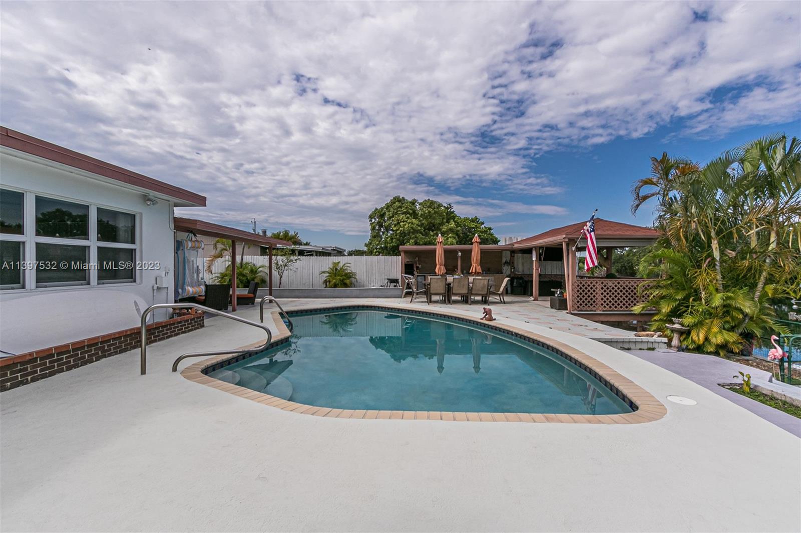 3820 Northwest 7th Avenue Deerfield Beach, FL 33064 - Photo 16 of 37 a view of a swimming pool with a patio