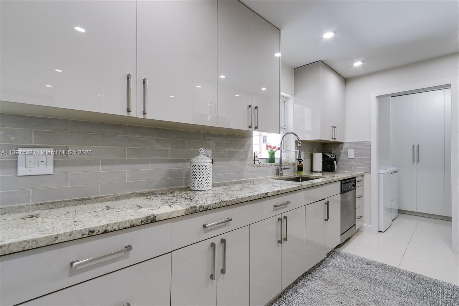 3820 Northwest 7th Avenue Deerfield Beach, FL 33064 - Photo 19 of 37 a kitchen with granite countertop white cabinets and a sink