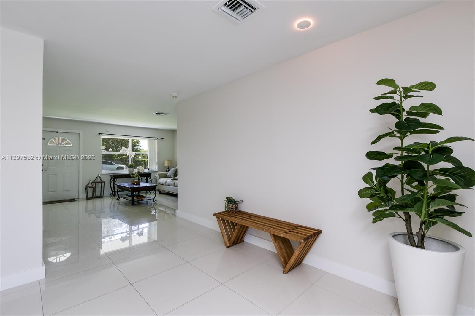 3820 Northwest 7th Avenue Deerfield Beach, FL 33064 - Photo 23 of 37 a living room with furniture and a potted plant
