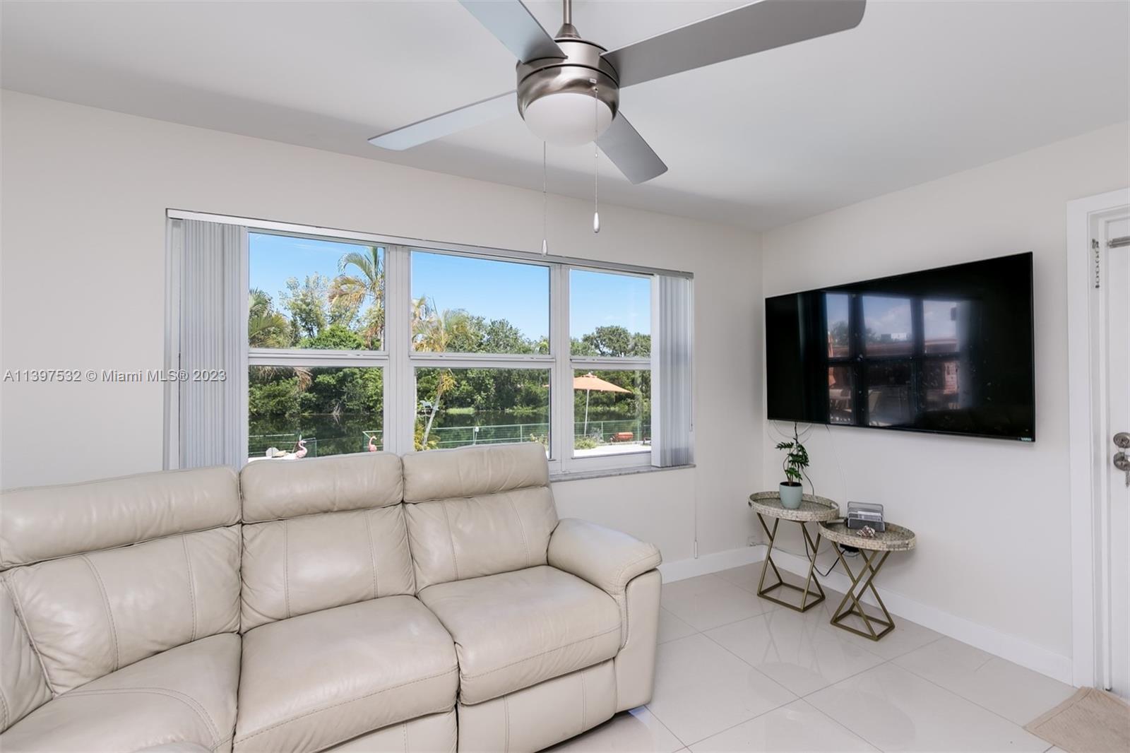 3820 Northwest 7th Avenue Deerfield Beach, FL 33064 - Photo 24 of 37 a living room with furniture and a flat screen tv
