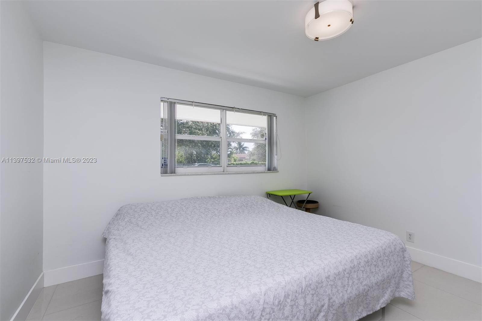 3820 Northwest 7th Avenue Deerfield Beach, FL 33064 - Photo 26 of 37 a bedroom with a bed and a window