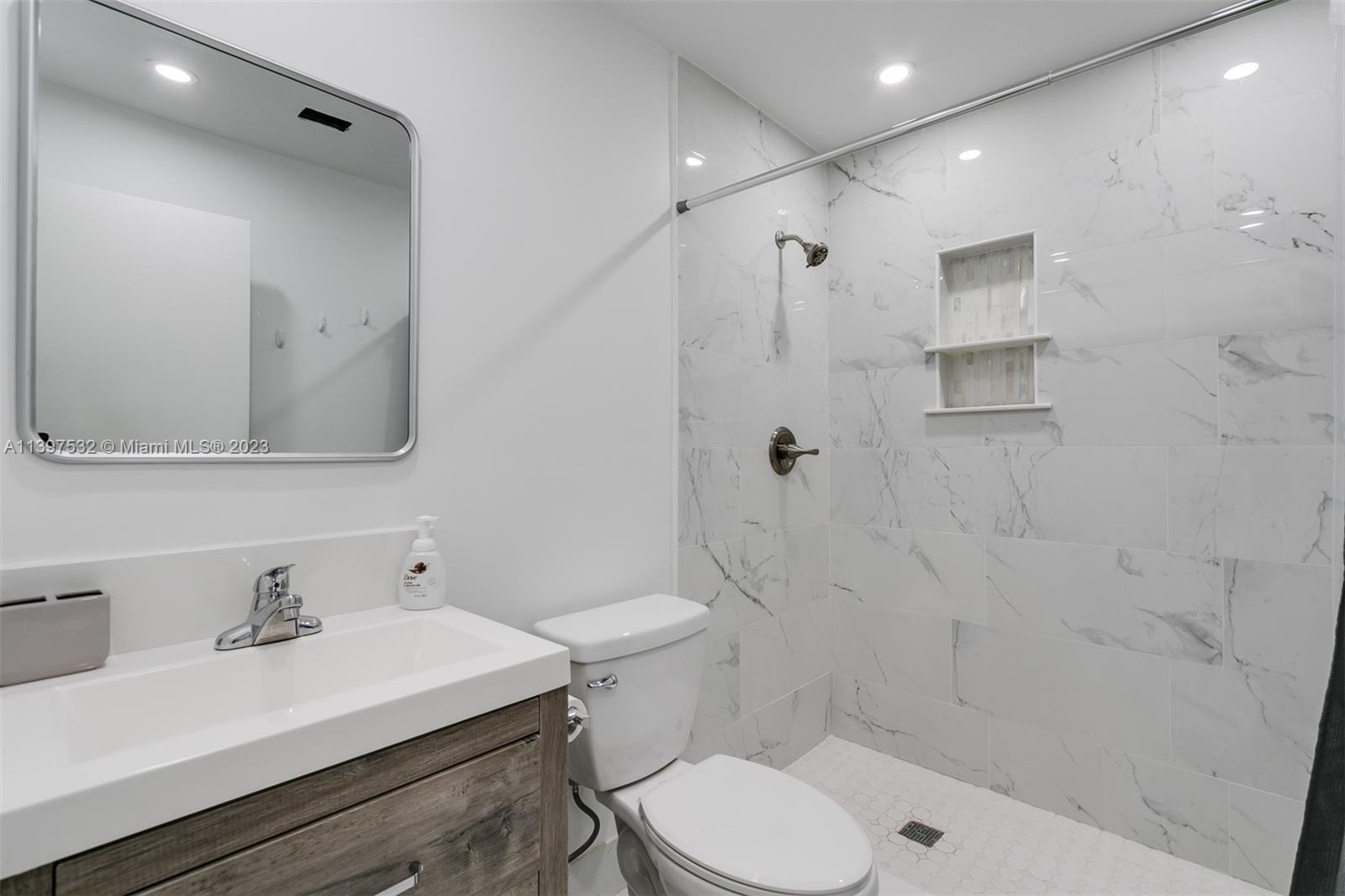 3820 Northwest 7th Avenue Deerfield Beach, FL 33064 - Photo 27 of 37 a bathroom with a sink toilet vanity and shower