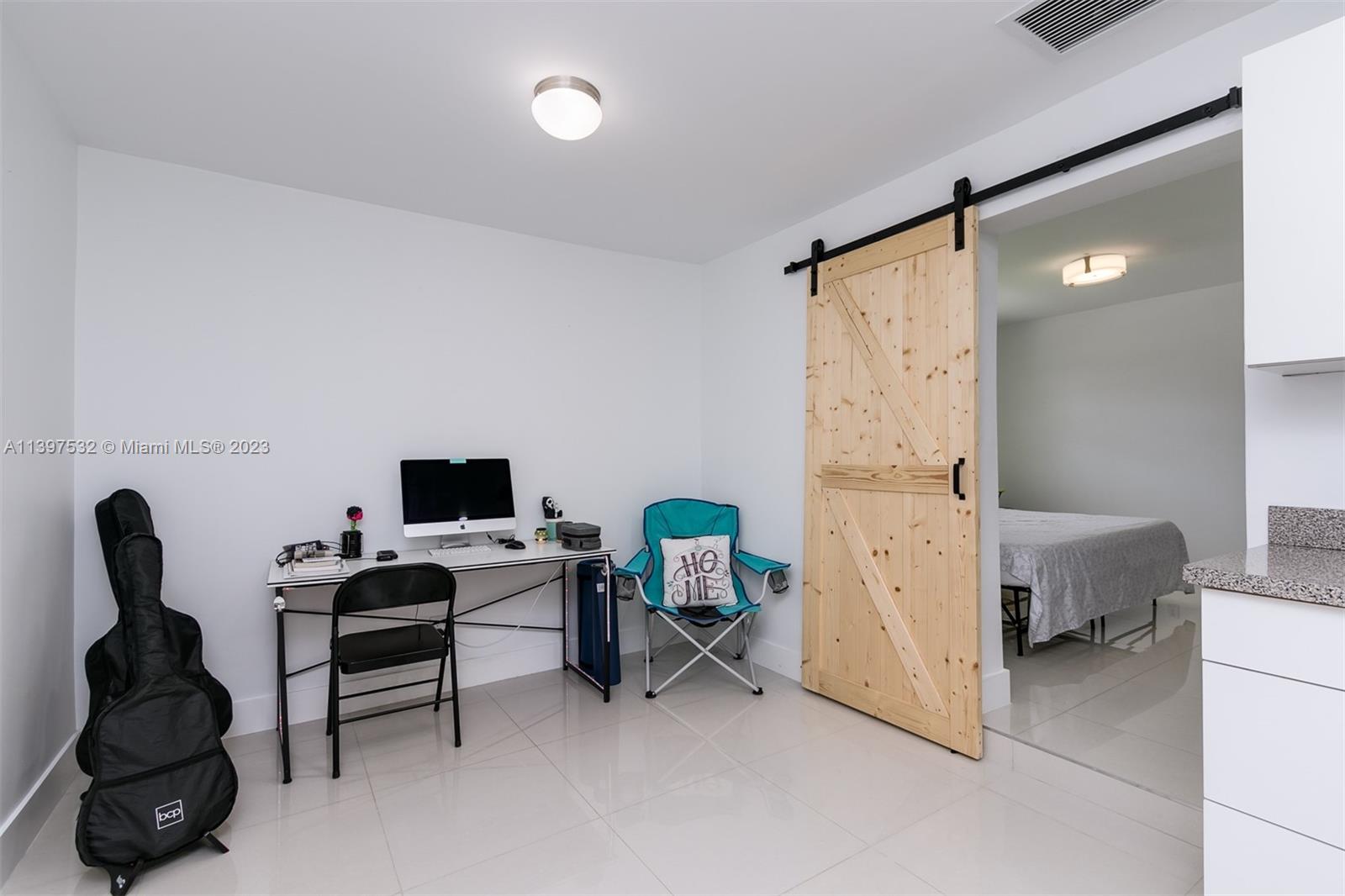 3820 Northwest 7th Avenue Deerfield Beach, FL 33064 - Photo 28 of 37 a view of a workspace with furniture and a window