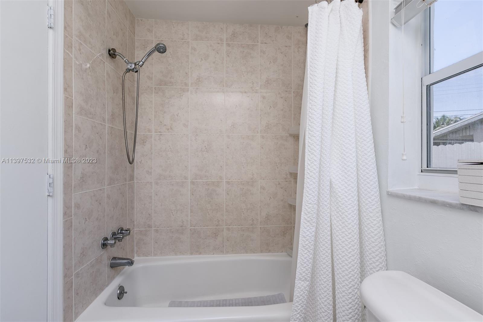 3820 Northwest 7th Avenue Deerfield Beach, FL 33064 - Photo 34 of 37 a bathroom with a shower and a toilet