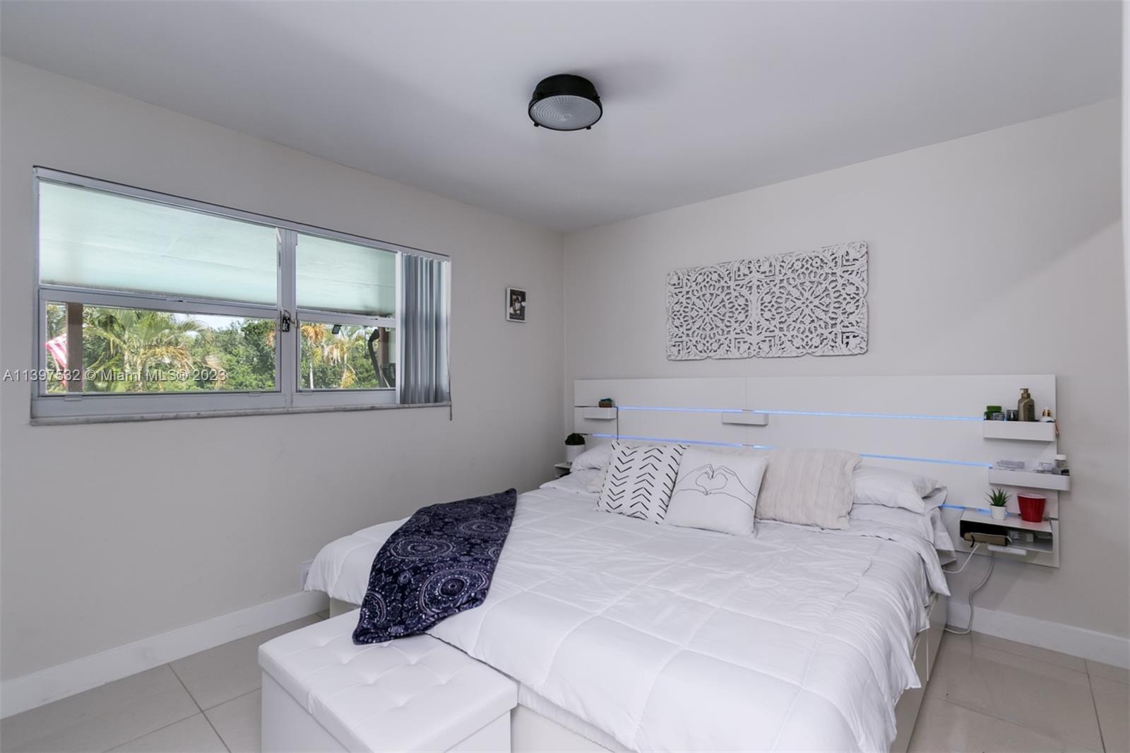 3820 Northwest 7th Avenue Deerfield Beach, FL 33064 - Photo 35 of 37 a bedroom with a bed and a window