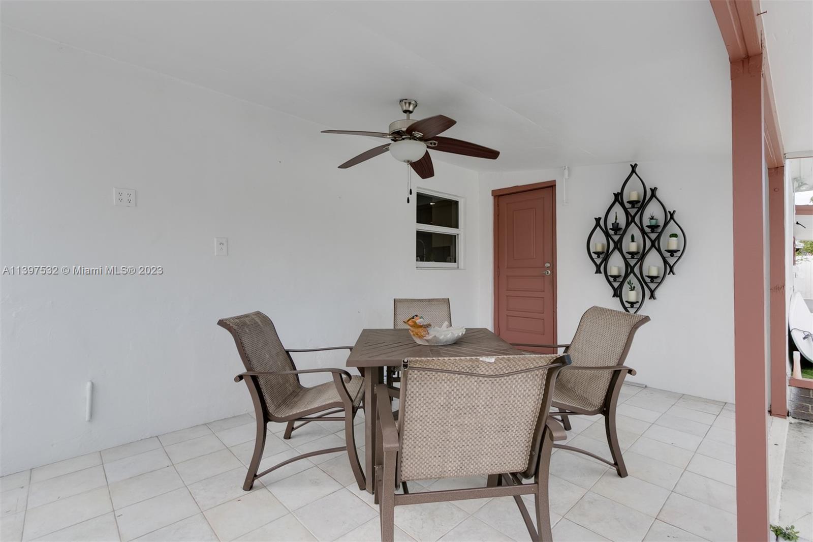 3820 Northwest 7th Avenue Deerfield Beach, FL 33064 - Photo 10 of 37 a dining room with furniture and chandelier fan