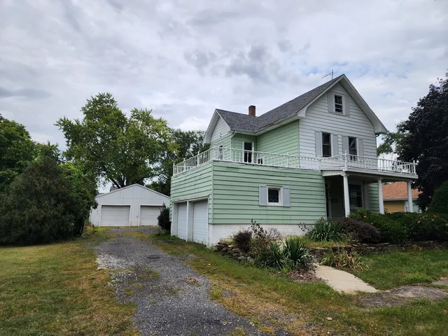 a front view of house with yard and trees