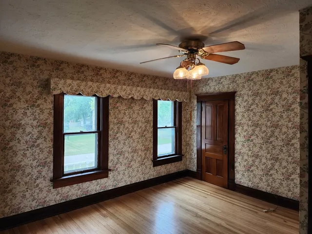 wooden floor in an empty room with a window