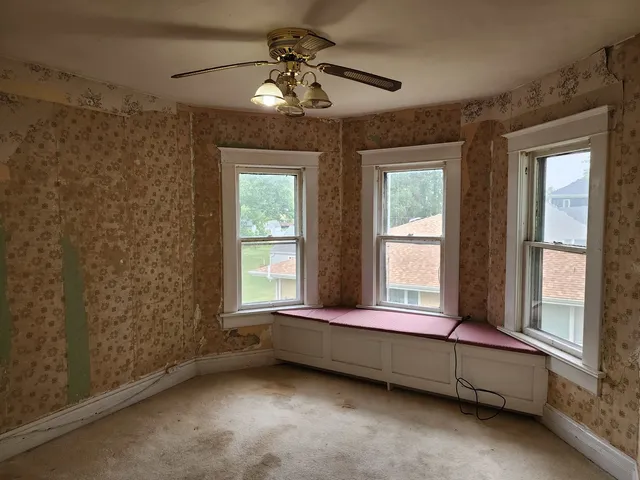 a bedroom with bed and window