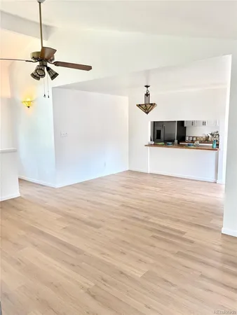 a view of a room with wooden floor and a window