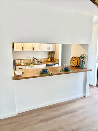 a kitchen with stainless steel appliances granite countertop a sink a stove and cabinets
