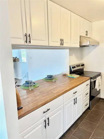 a kitchen with stainless steel appliances a stove a refrigerator and cabinets
