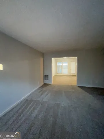 a white toilet sitting next to a bathroom sink and a mirror