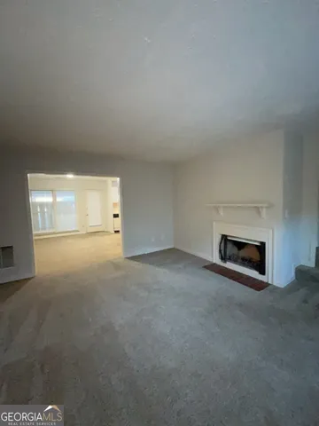 a view of empty room with a fireplace