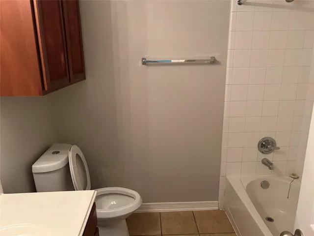 a bathroom with a toilet and a tub
