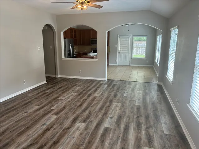 a view of a livingroom with wooden floor and a window