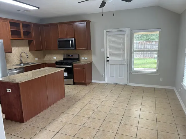 a kitchen with a stove a sink and a refrigerator