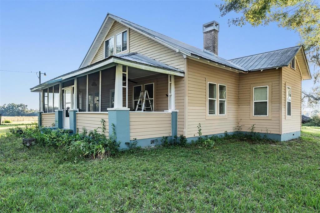 a view of a house with wooden fence