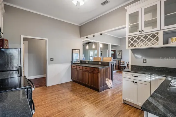 a kitchen with stainless steel appliances granite countertop a sink and wooden cabinets