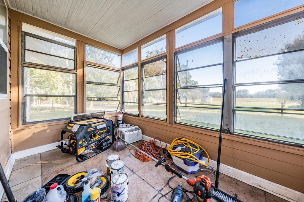 7207 Elwood Road Zephyrhills, FL 33540 - Photo 16 of 23 a bedroom with furniture and a large window