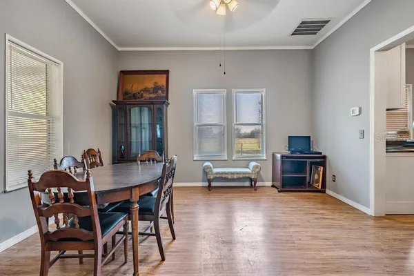 a dining room with furniture and window
