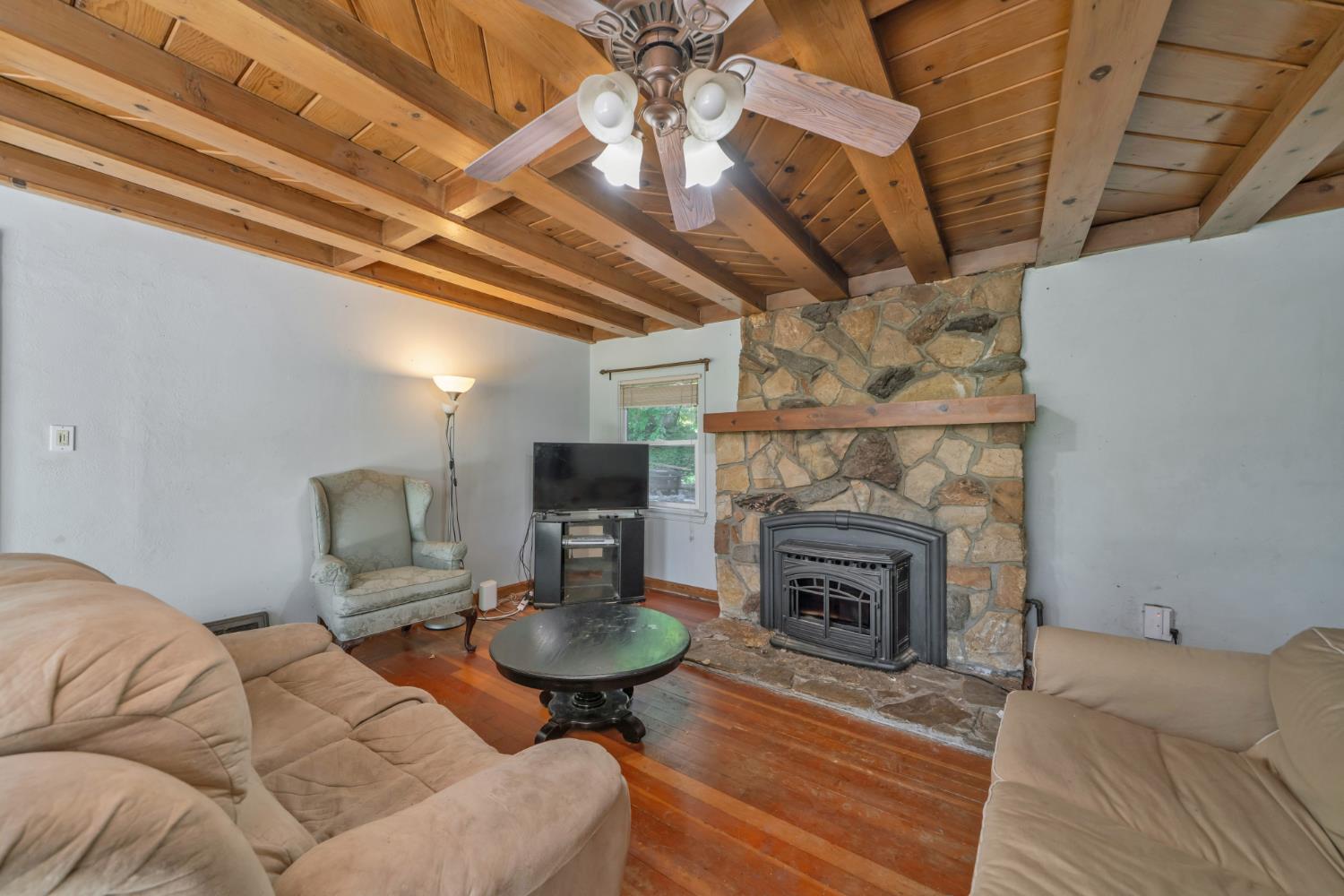 6929 Split Bend Road Pollock Pines, CA 95726 - Photo 21 of 38 a living room with furniture a fireplace and a table