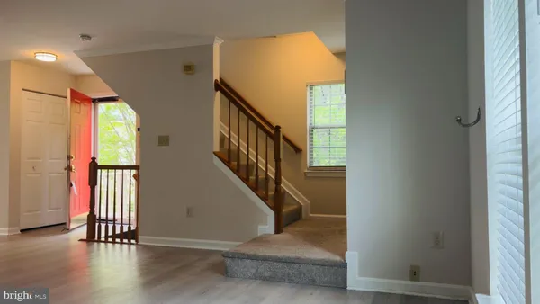 a view of entryway with wooden floor and stairs