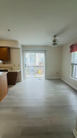 a view of an empty room with a fireplace and a window
