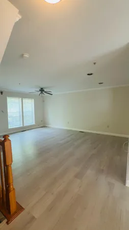 a view of a room with gym equipment and windows