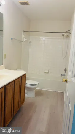 a bathroom with a sink a toilet and a shower