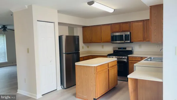 a kitchen with a refrigerator stove and microwave
