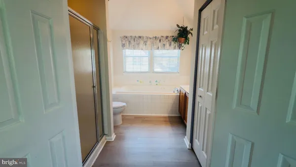 a bathroom with a granite countertop shower a toilet and a sink