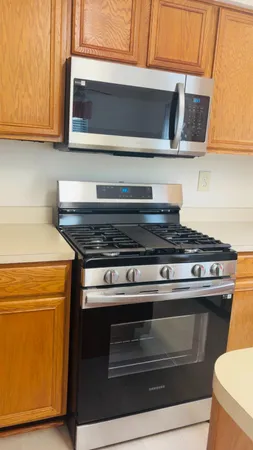 a stove top oven sitting inside of a kitchen