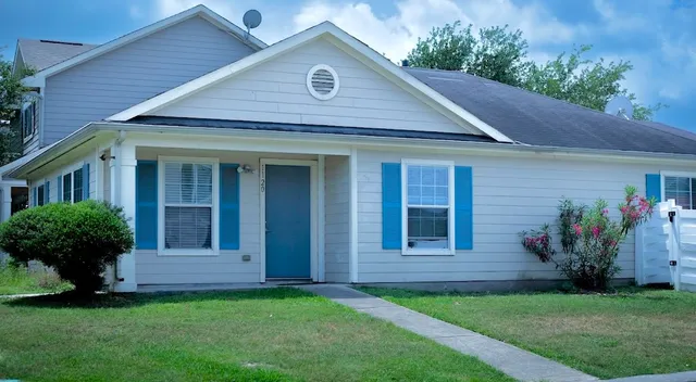 a front view of a house with garden