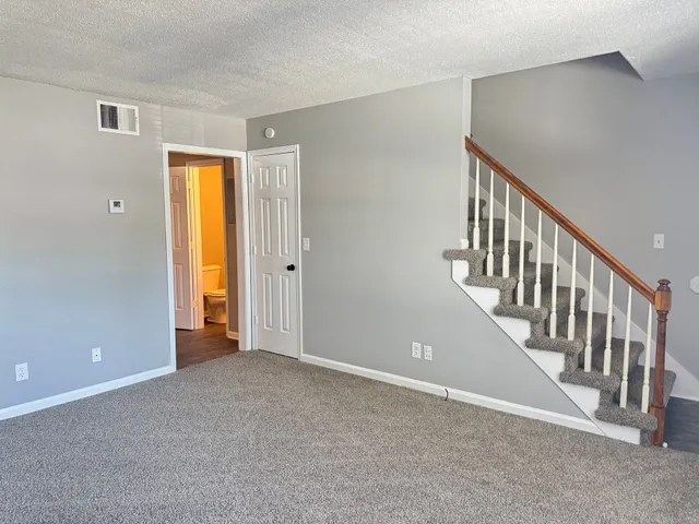 a view of an empty room with stairs