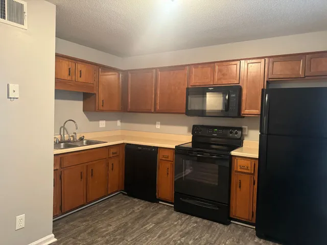 a kitchen with a sink stove and microwave