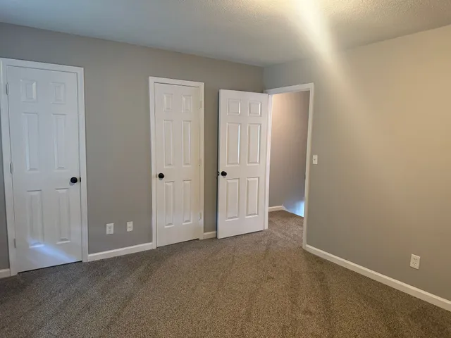 a view of an empty room with closet area