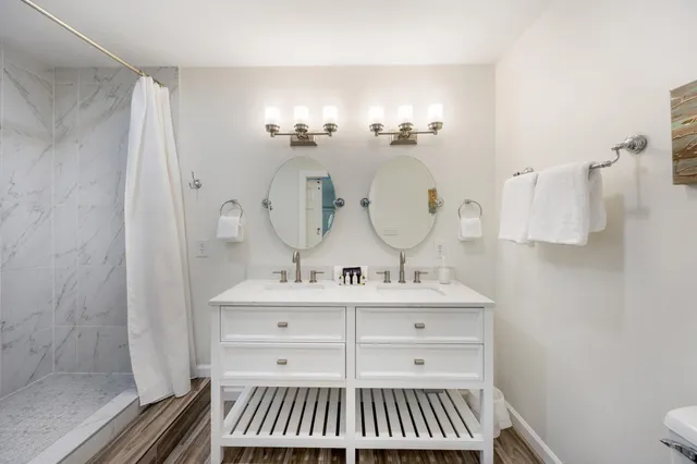 a bathroom with a shower and a sink