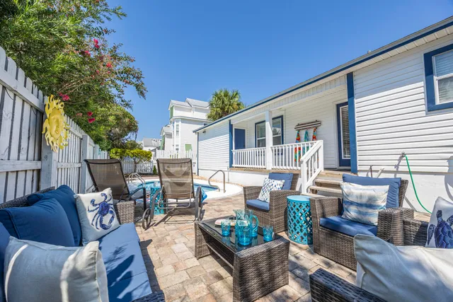 a view of a house with backyard and sitting area