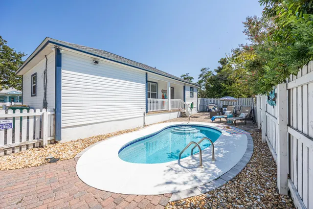 a backyard of a house with table and chairs