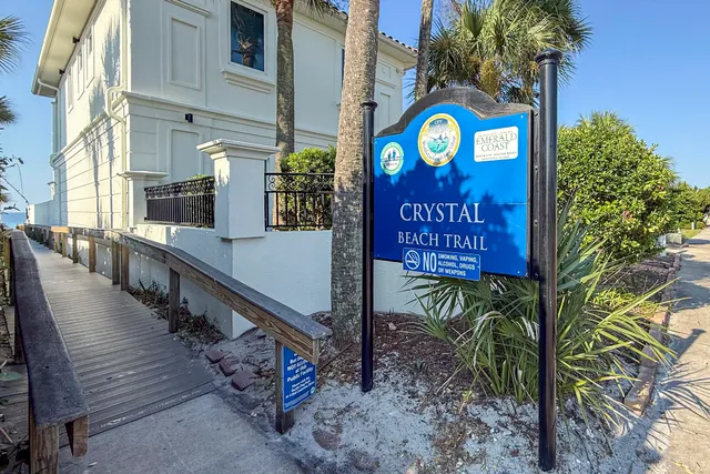 a view of a street with potted plants