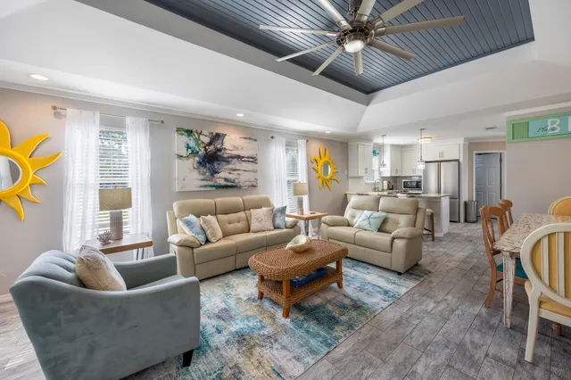 a living room with furniture ceiling fan and a rug