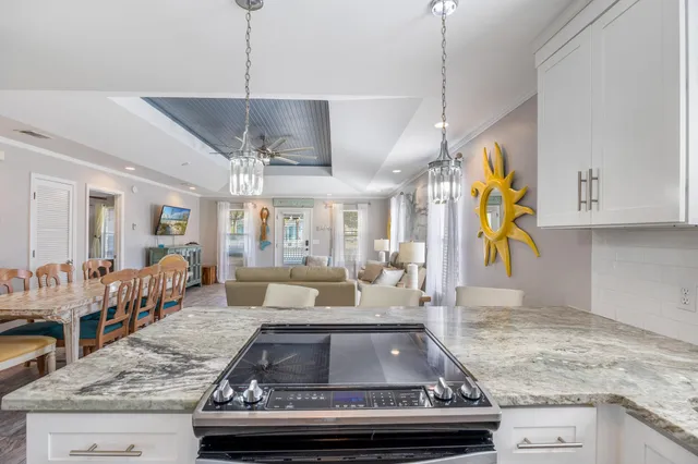 a living room with stainless steel appliances granite countertop furniture and a kitchen view
