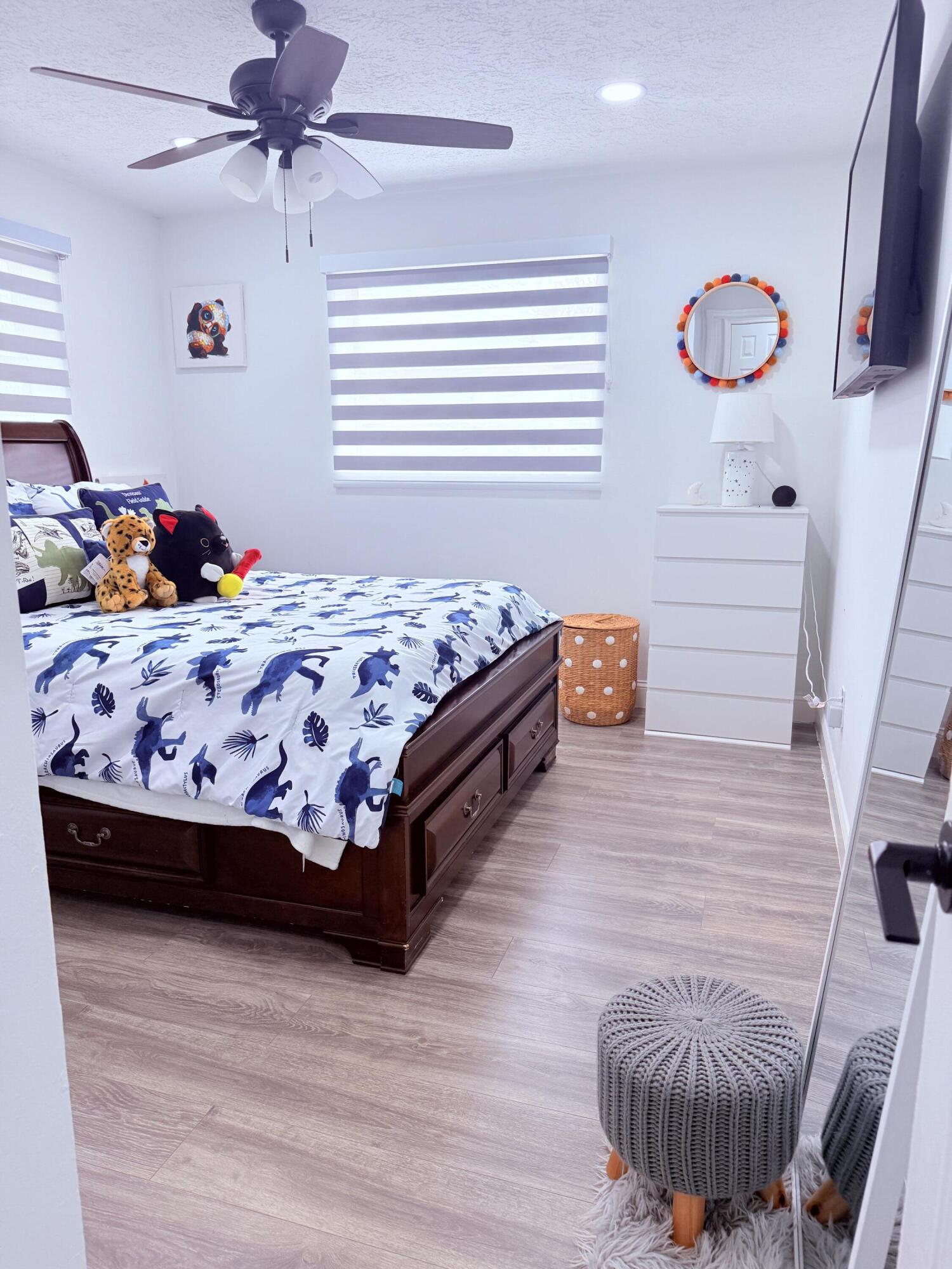 302 Southwest Whitmore Drive Port St. Lucie, FL 34984 - Photo 12 of 21 a bedroom with a bed and a window