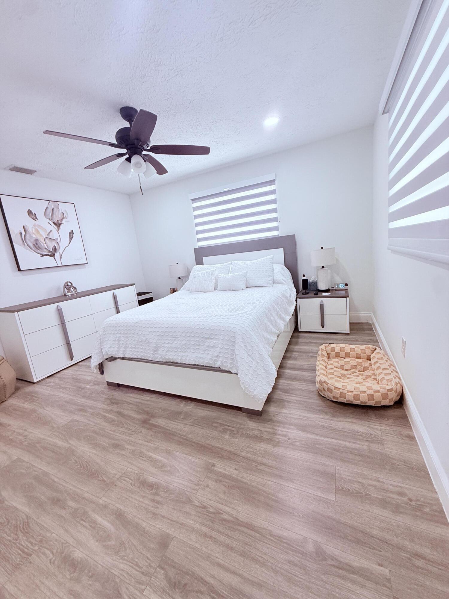 302 Southwest Whitmore Drive Port St. Lucie, FL 34984 - Photo 13 of 21 a bedroom with a bed and a window