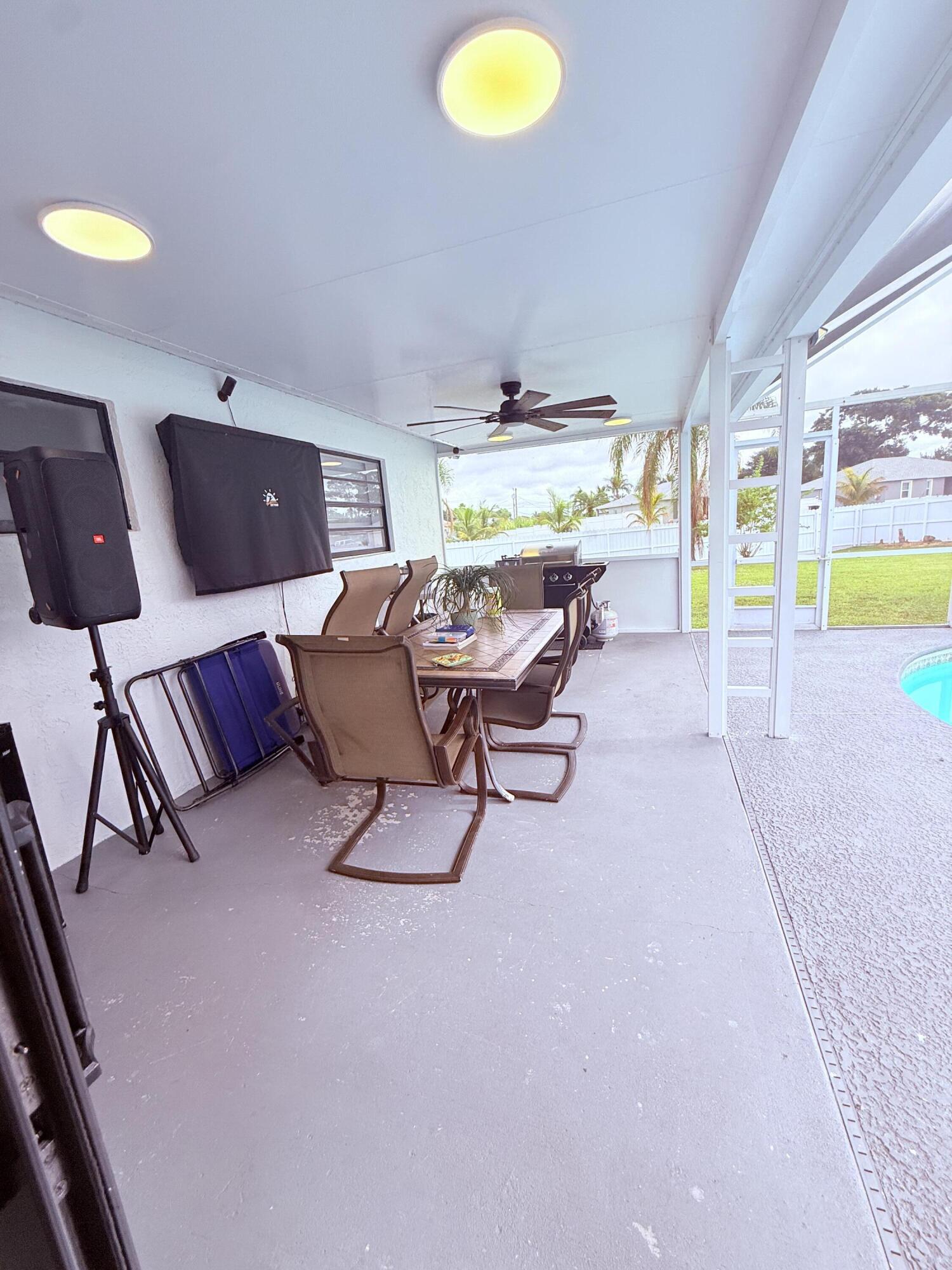 302 Southwest Whitmore Drive Port St. Lucie, FL 34984 - Photo 16 of 21 a living room with furniture and a flat screen tv