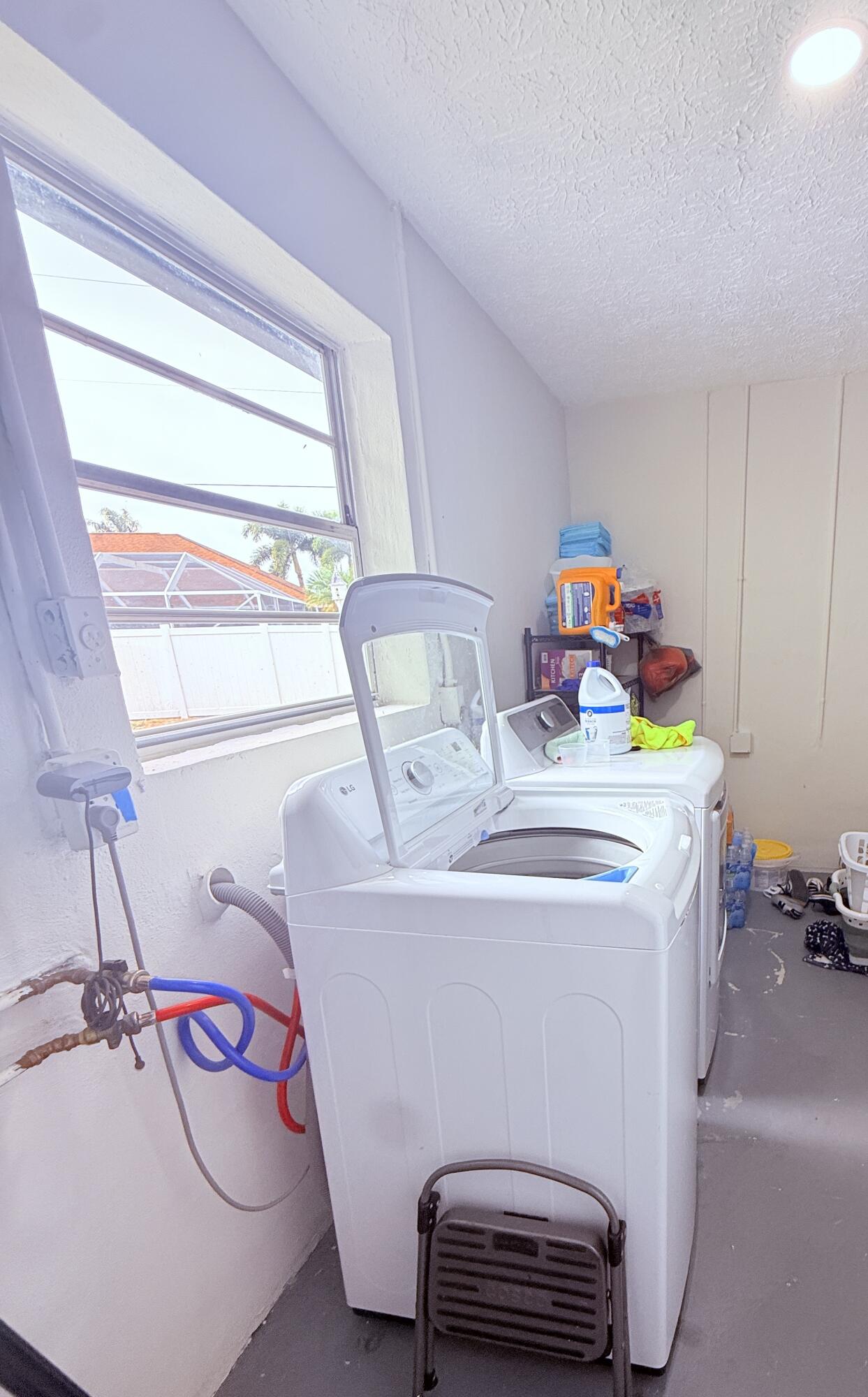 302 Southwest Whitmore Drive Port St. Lucie, FL 34984 - Photo 18 of 21 a utility room with dryer and washer