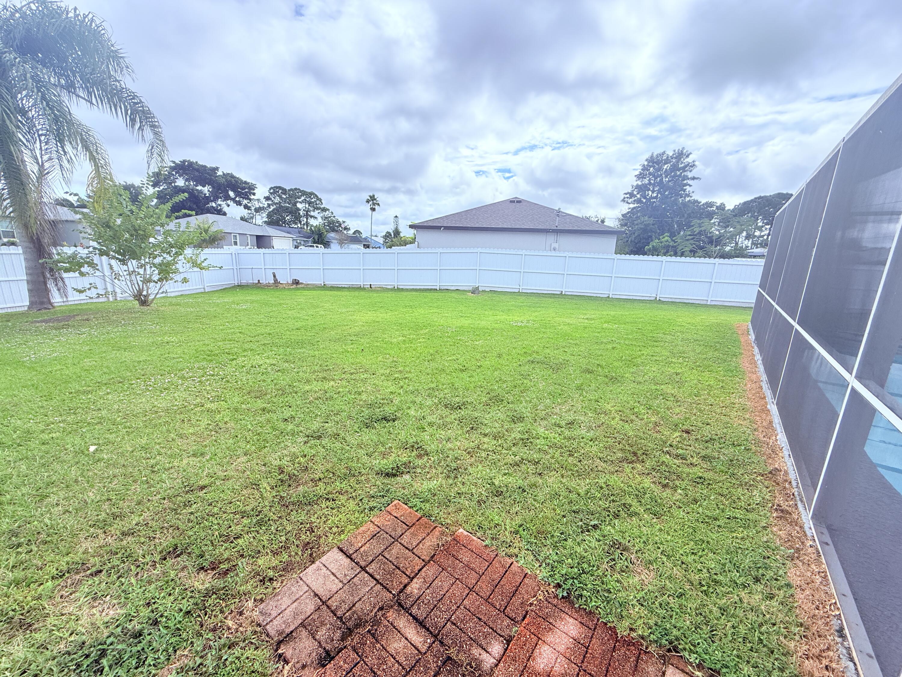 302 Southwest Whitmore Drive Port St. Lucie, FL 34984 - Photo 19 of 21 a view of yard with seating area