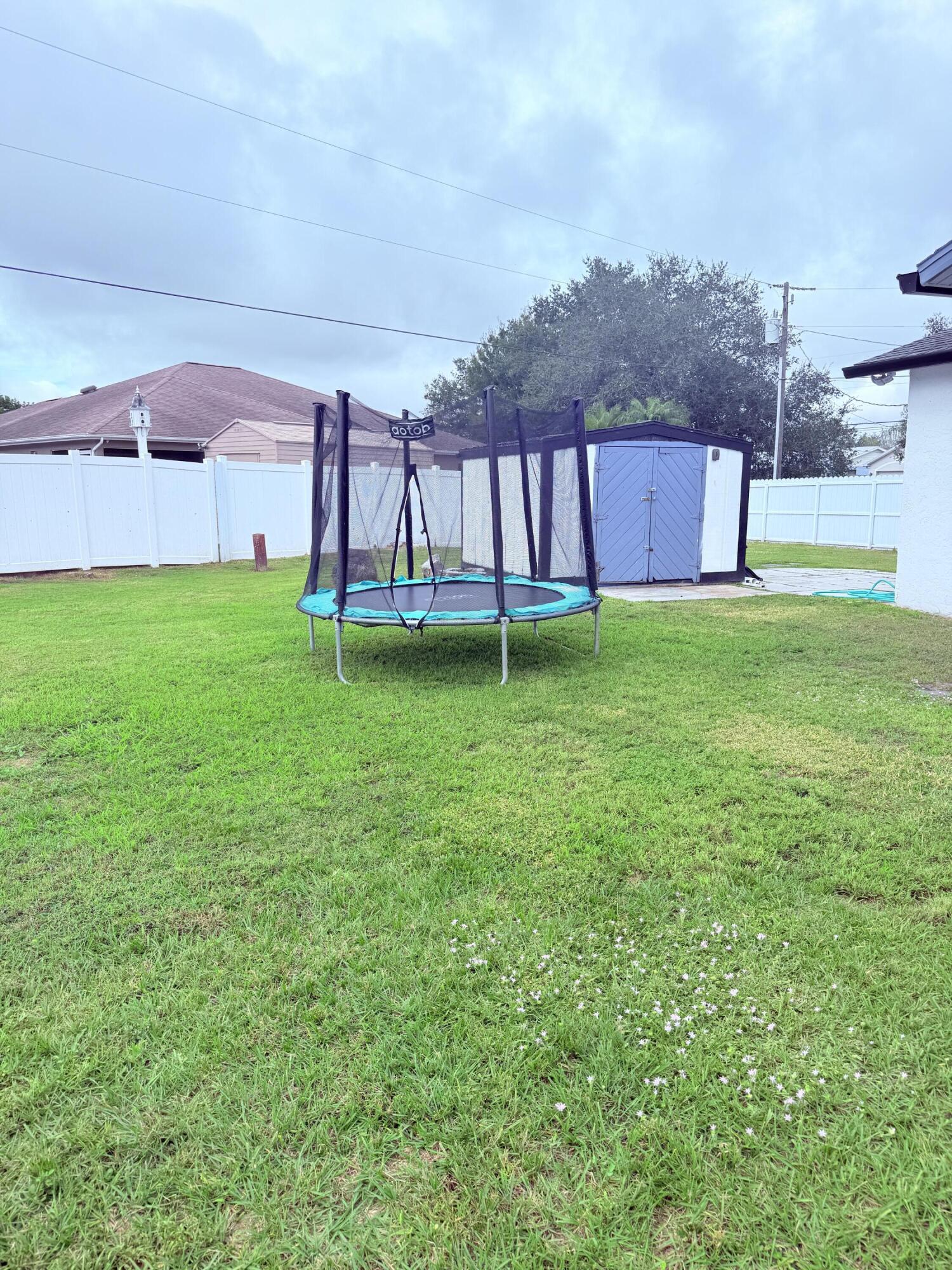 302 Southwest Whitmore Drive Port St. Lucie, FL 34984 - Photo 20 of 21 a backyard of a house with lots of green space and mountain view